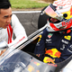 Takuma Sato, left, talks with Max Verstappen before Verstappen drives the Honda RA272 ahead of the 2019 Japanese Grand Prix.